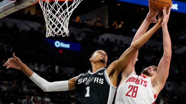 Rockets center Alperen Sengun (28) shoots over San Antonio Spurs forward Victor Wembanyama (1) during the first half against at Frost Bank Center.